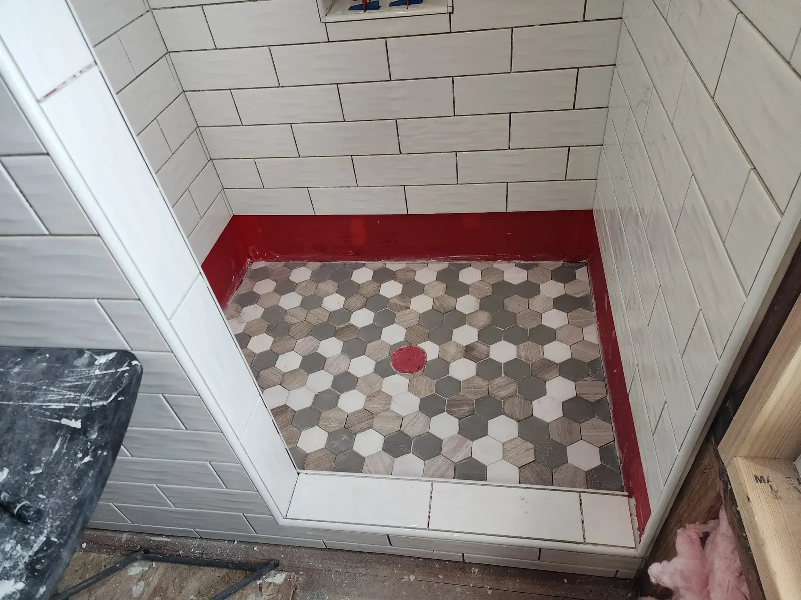 Tiled shower floor during the cabin remodel