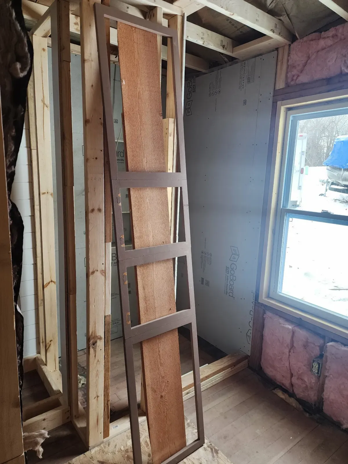 Bathroom wall framing around a window during the cabin remodel
