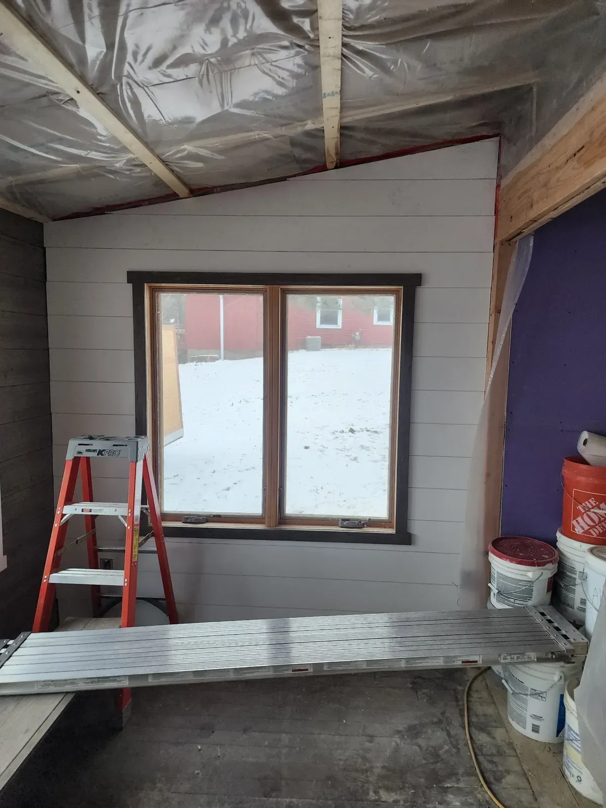 Interior wall paneling and window trim during the cabin remodel