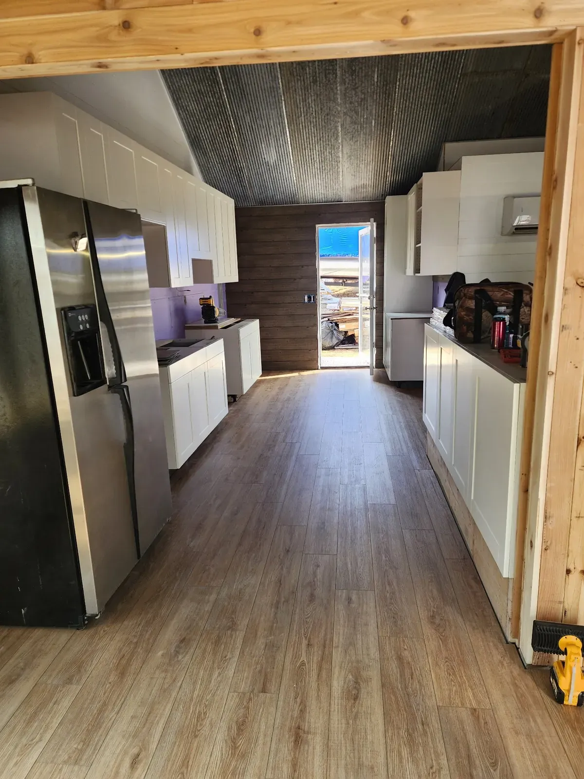 Cabin kitchen cabinets, flooring, and appliances during the finish stage