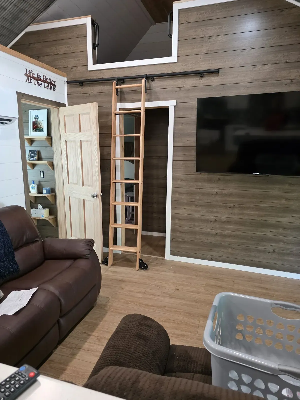 Living room with rolling loft ladder after the cabin remodel