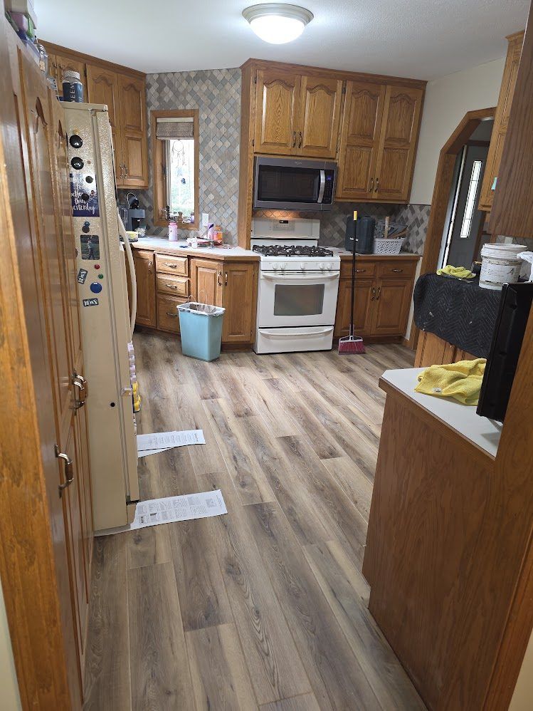Finished kitchen with a new tile backsplash and wood-look flooring