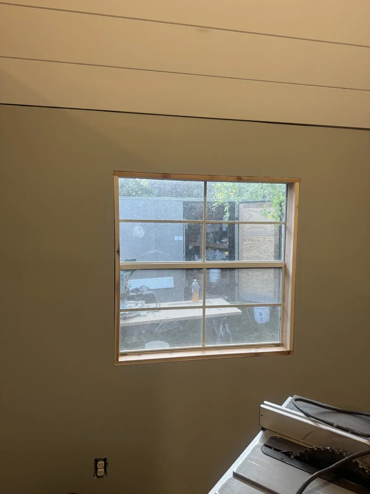 Finished window wall with painted walls and a wood-trimmed window