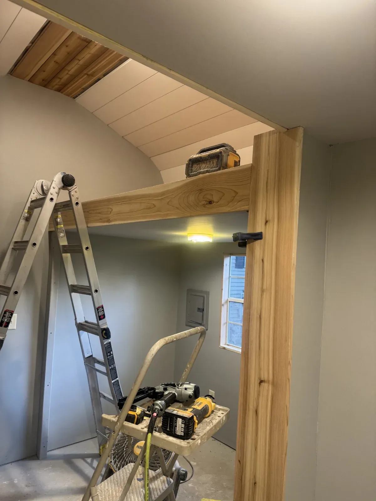 Nearly finished interior with a ladder and tools still in frame during final touches