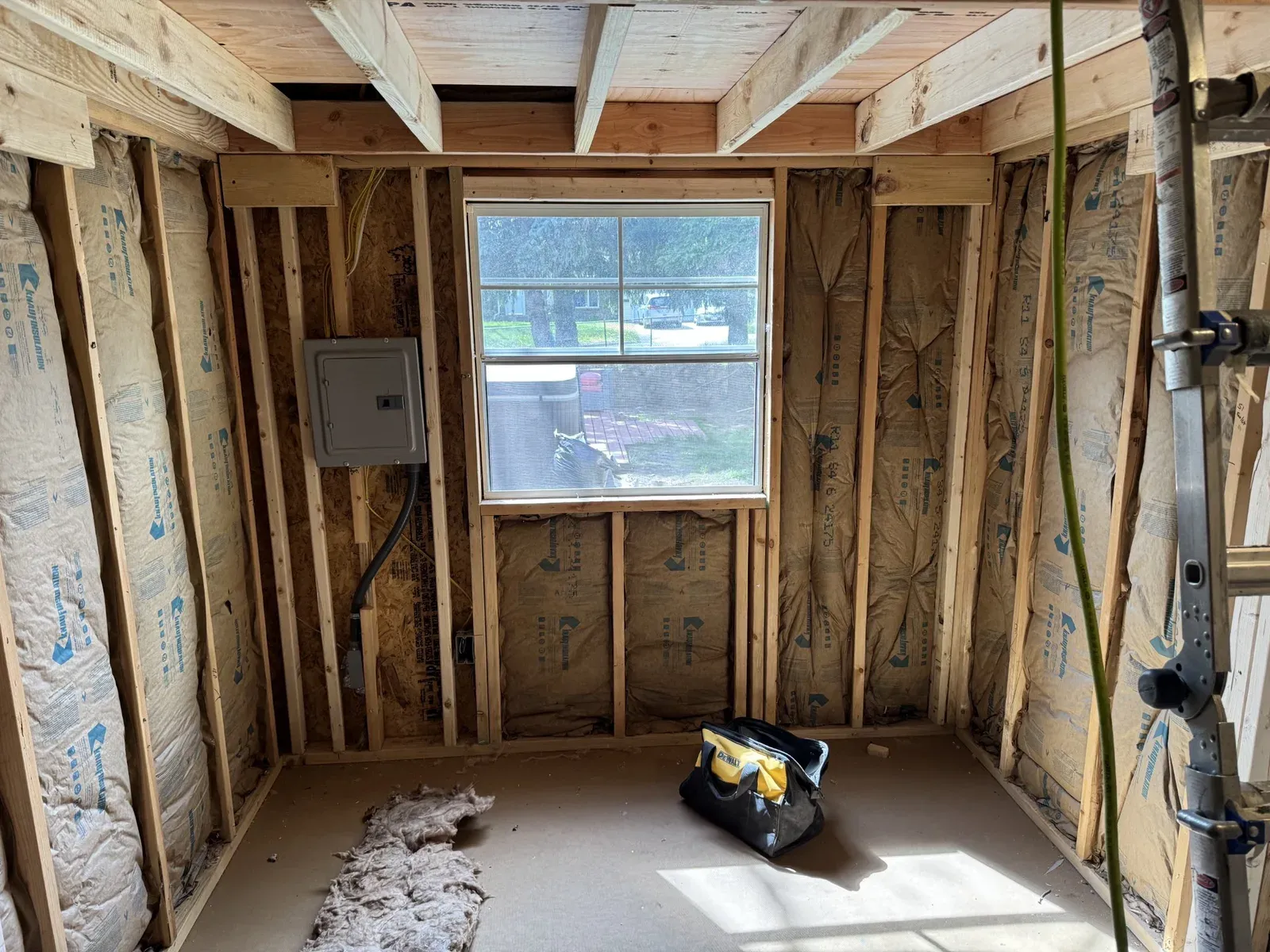 Window wall framed and insulated, with the electrical panel mounted beside the window