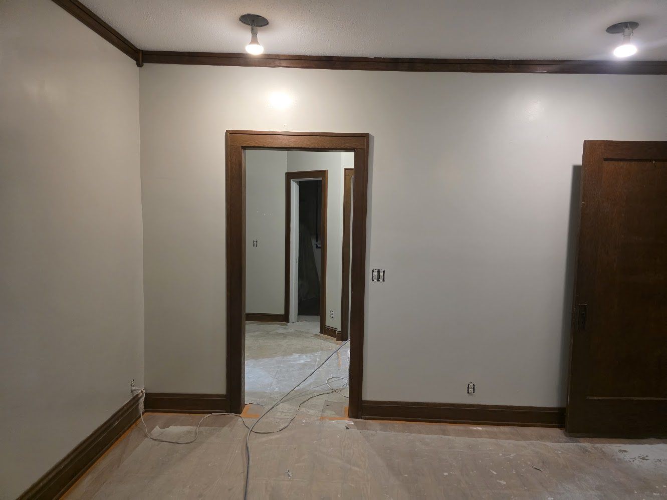 Finished room with clean white walls and refinished wood floor