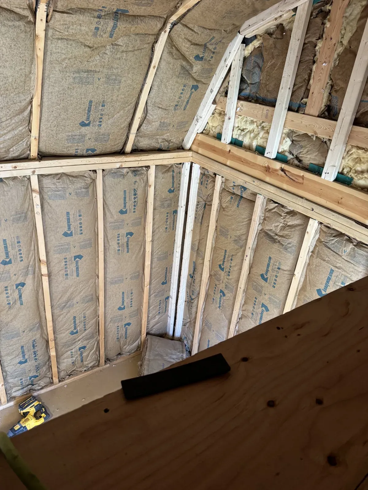 Insulated stud walls seen from the loft during the shed conversion