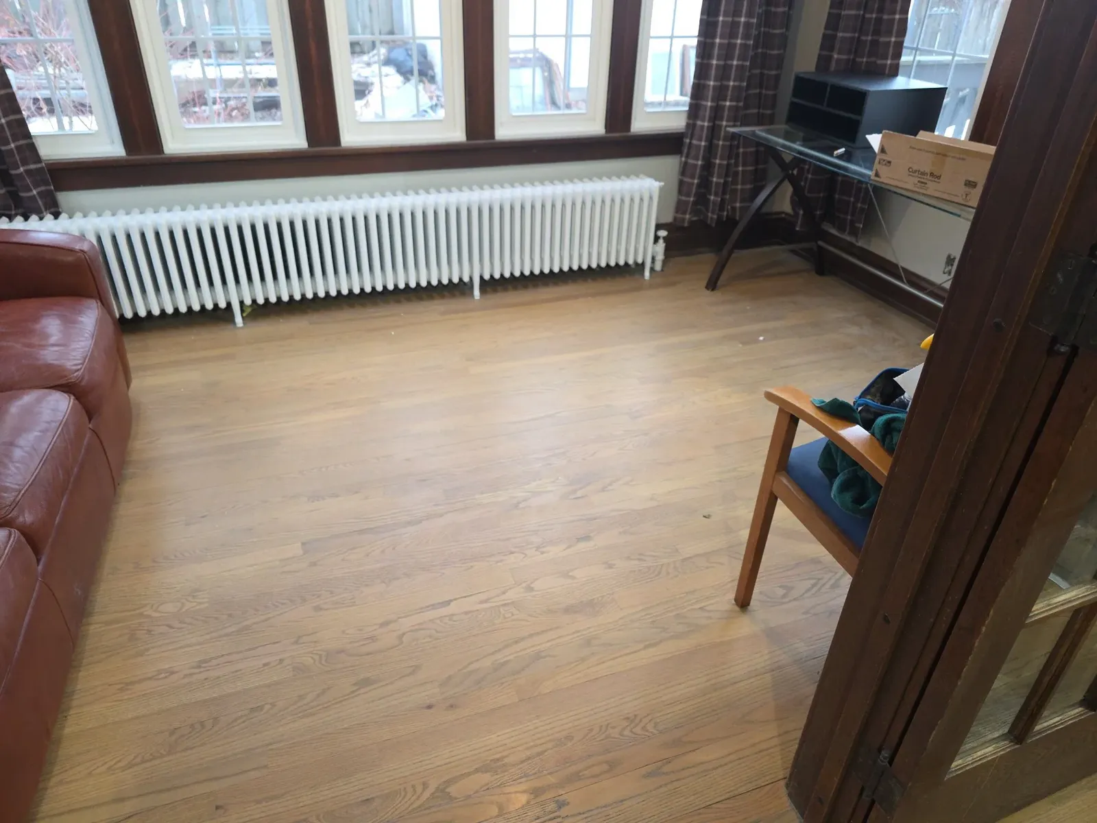 Finished sunroom with refinished hardwood floors