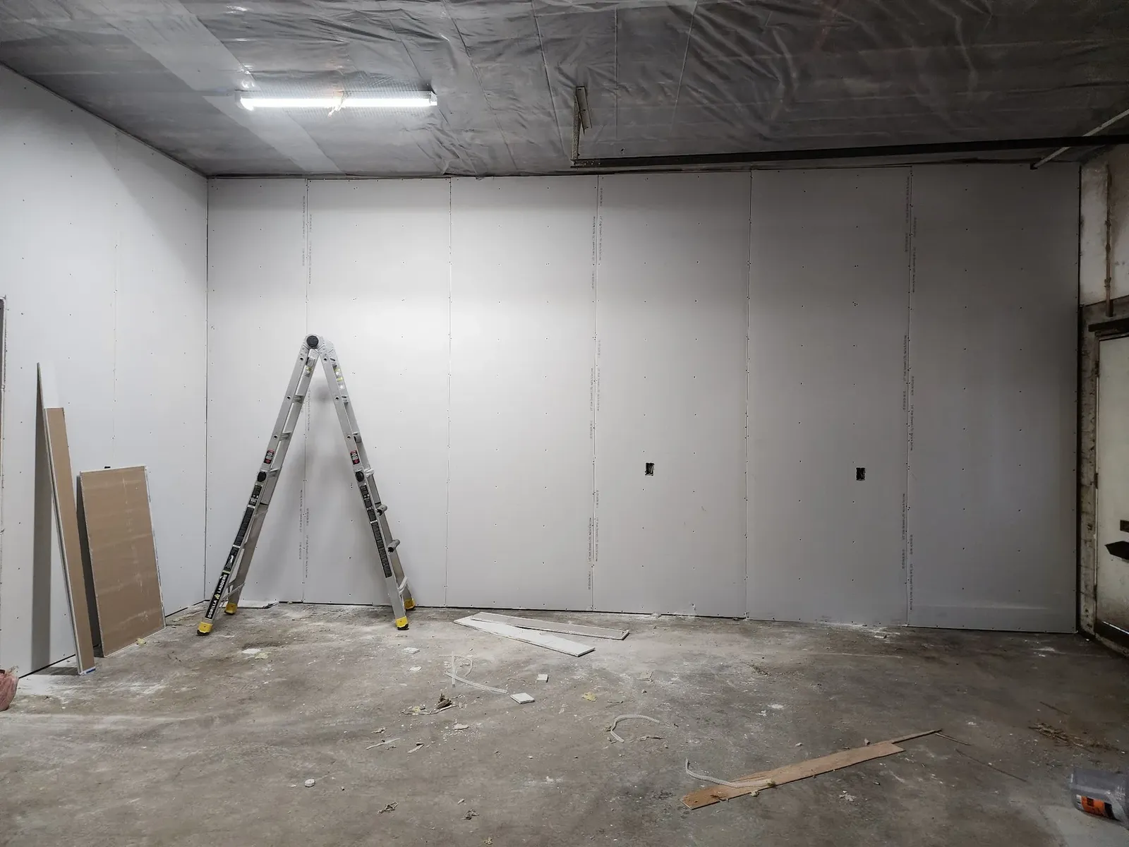 New drywall installed on the former garage walls during construction