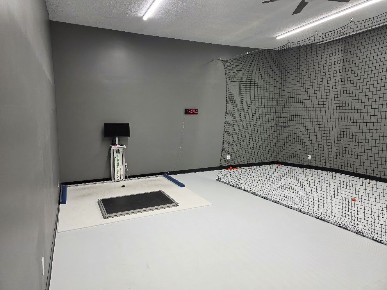 Finished hockey shooting lane with synthetic ice and netting