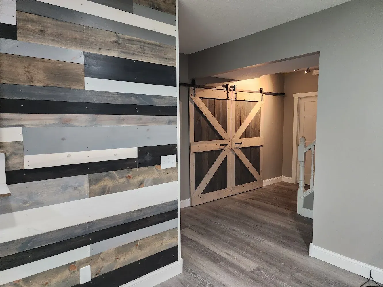 Finished reclaimed-wood accent wall and barn doors