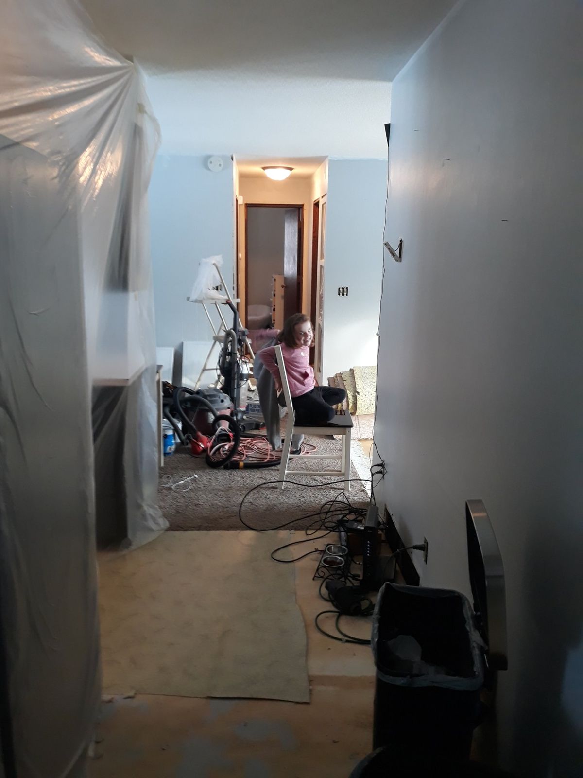 Living room with flooring removed to the subfloor during demolition