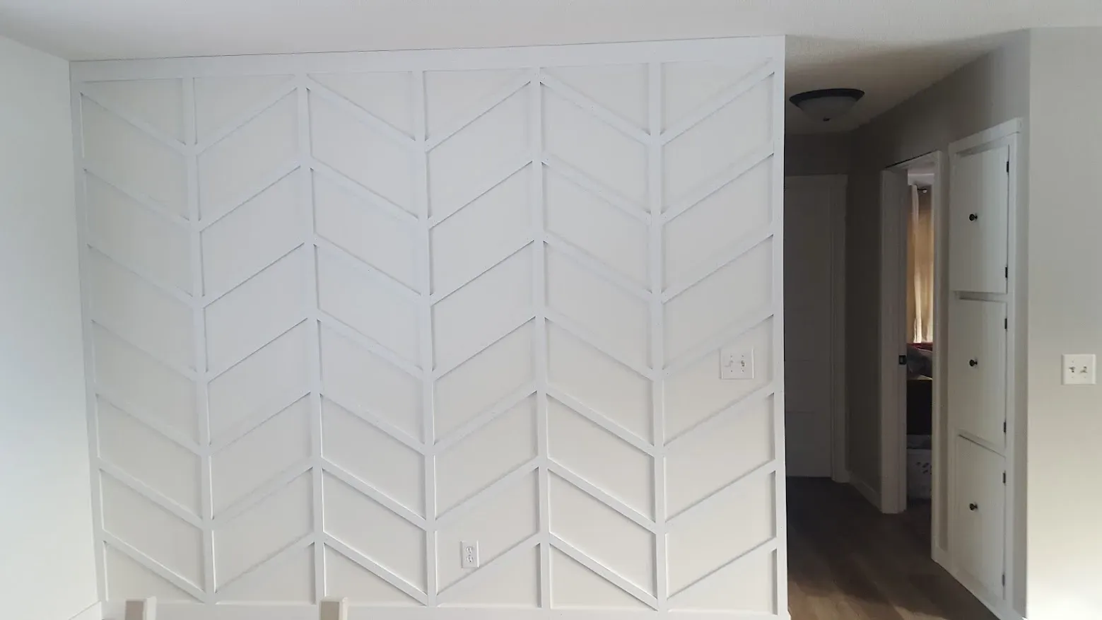 Finished main floor with a custom white chevron accent wall