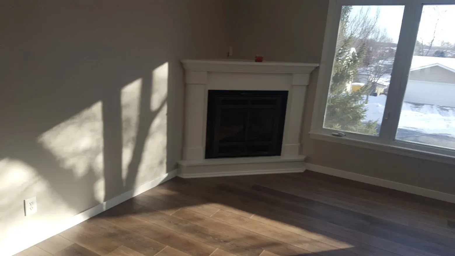 Living room fireplace refinished with crisp white paint