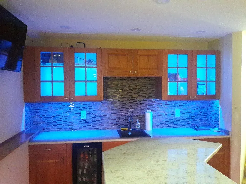 Basement wet bar under construction with cabinets and countertop installed