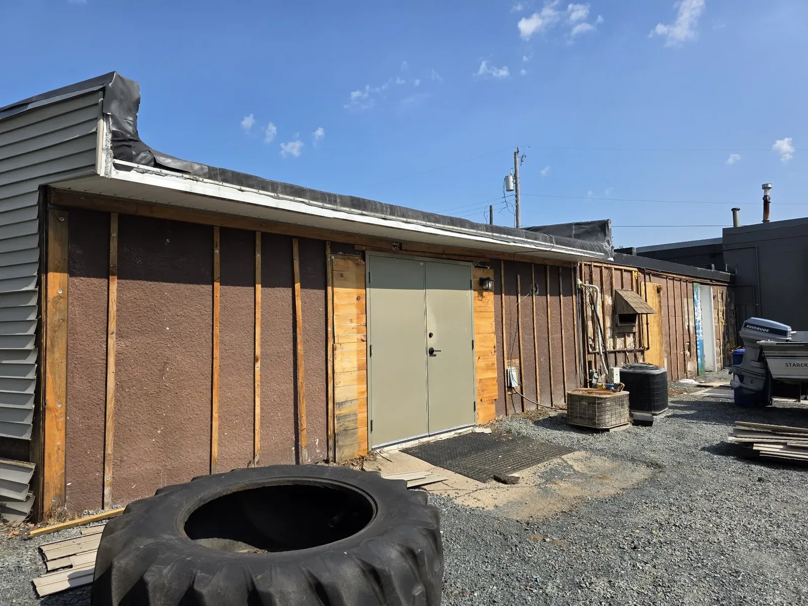 Rear exterior stripped with new doors being installed
