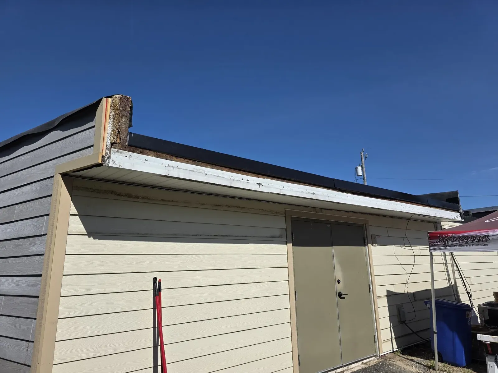 Finished light-colored siding and trim on the rear of the performance center