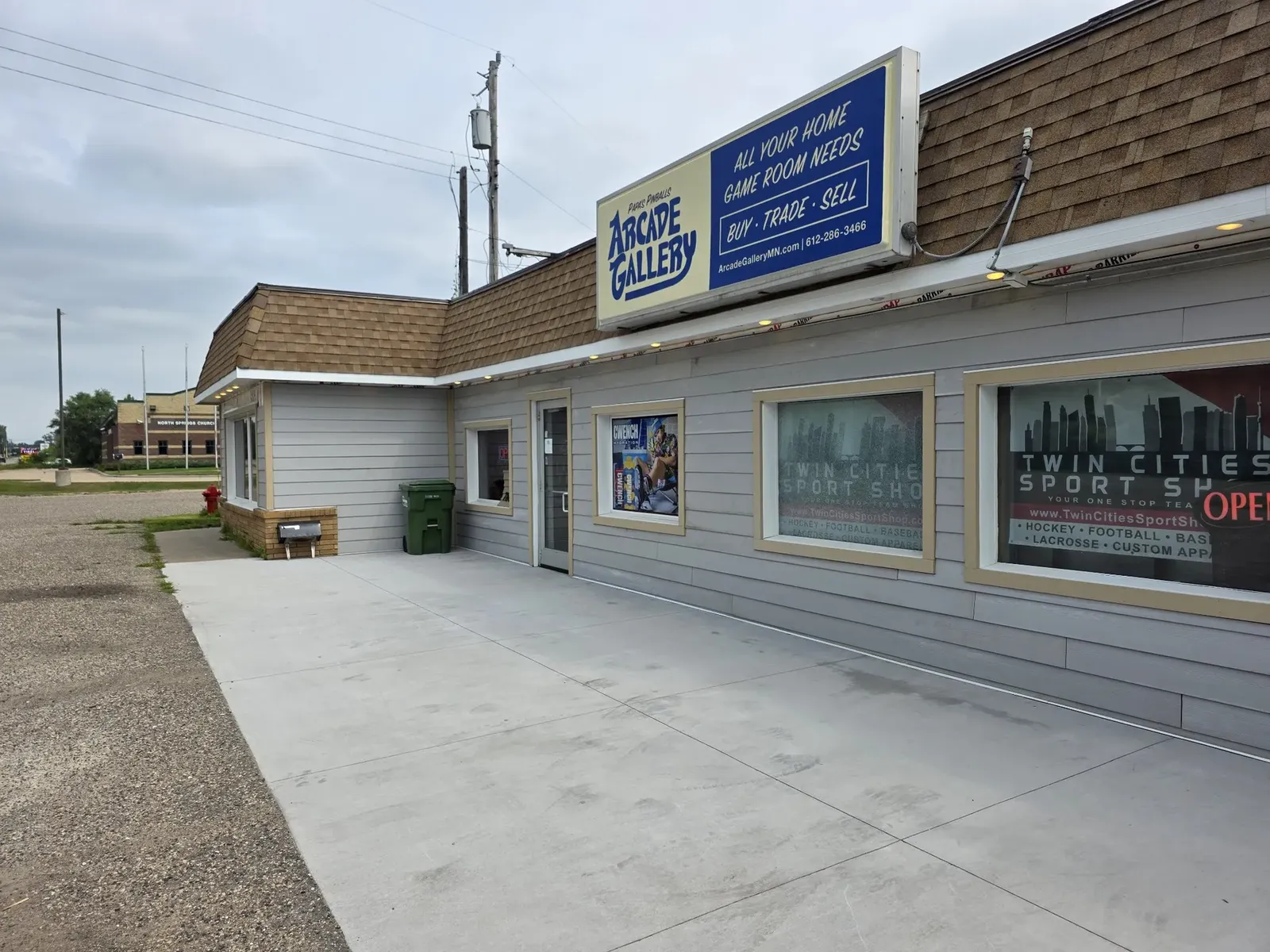 Finished performance center storefront with new gray siding and white trim