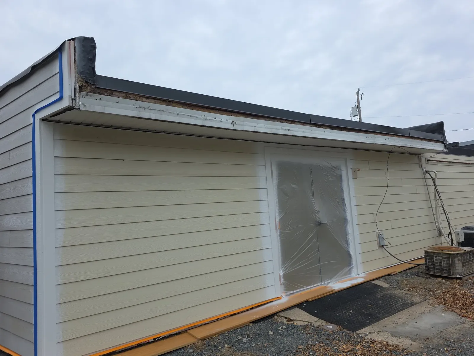 Finished light-colored siding on the performance center side wall