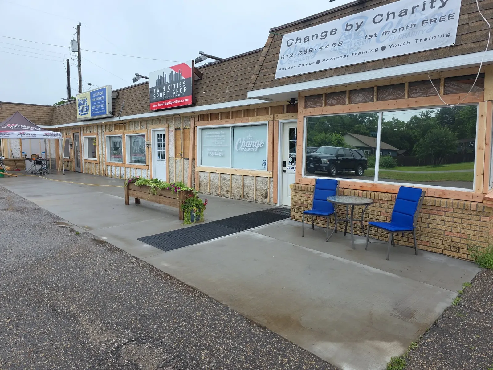 Finished performance center storefront with new siding, trim, and seating area