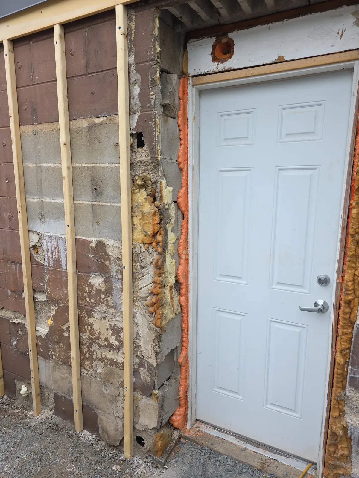Close view of the rear door installation detail during exterior renovation