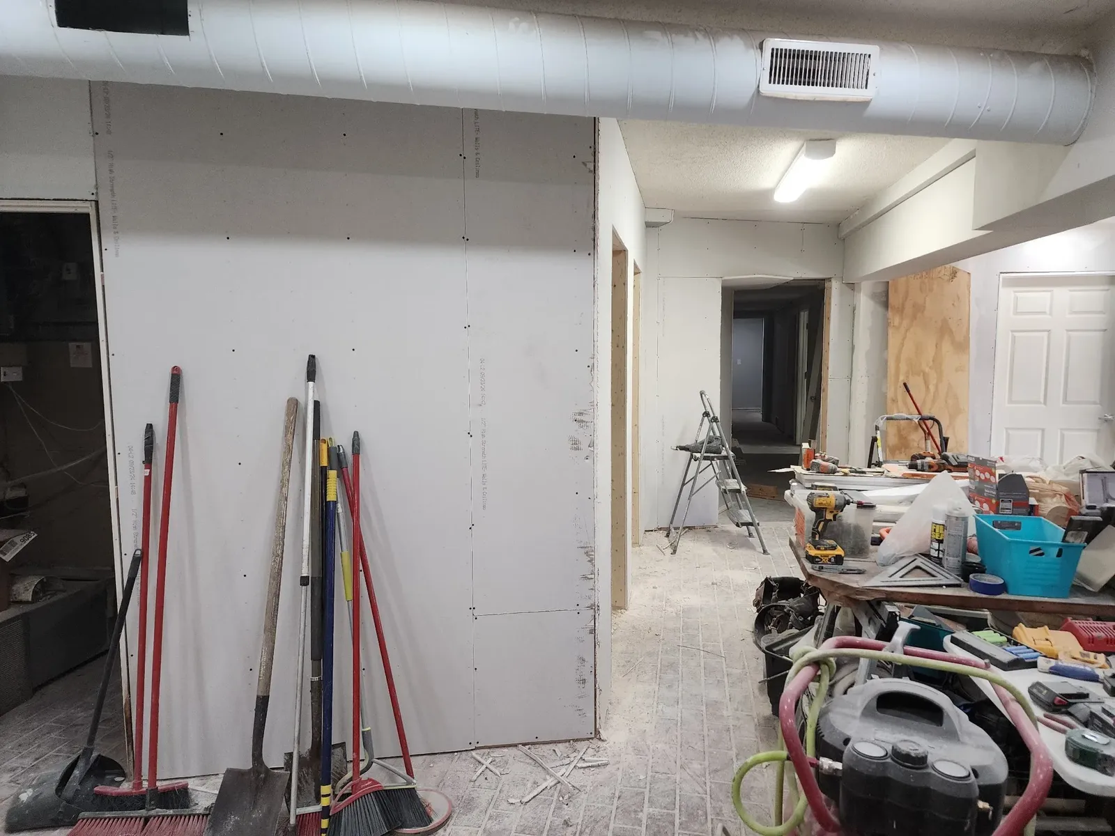 Hallway drywall installation during the commercial gym remodel