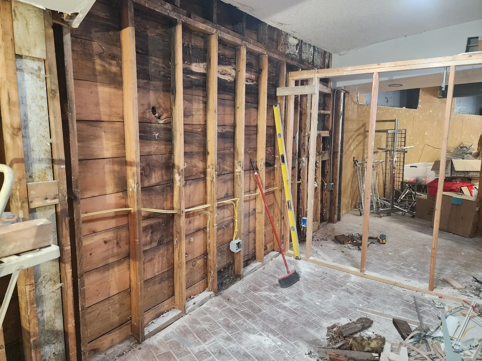 Exposed wood framing during demolition for the commercial gym remodel