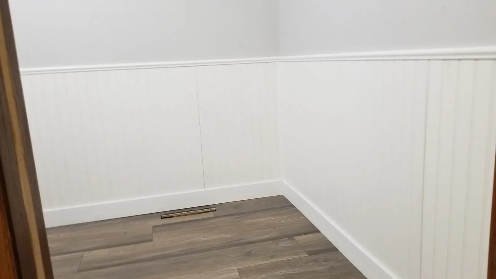 Beadboard wainscoting and new flooring being installed in the church powder room