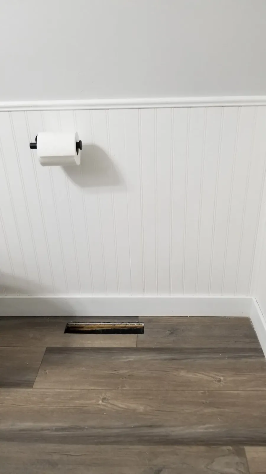 Finished beadboard wainscoting before the powder-room fixtures were reinstalled