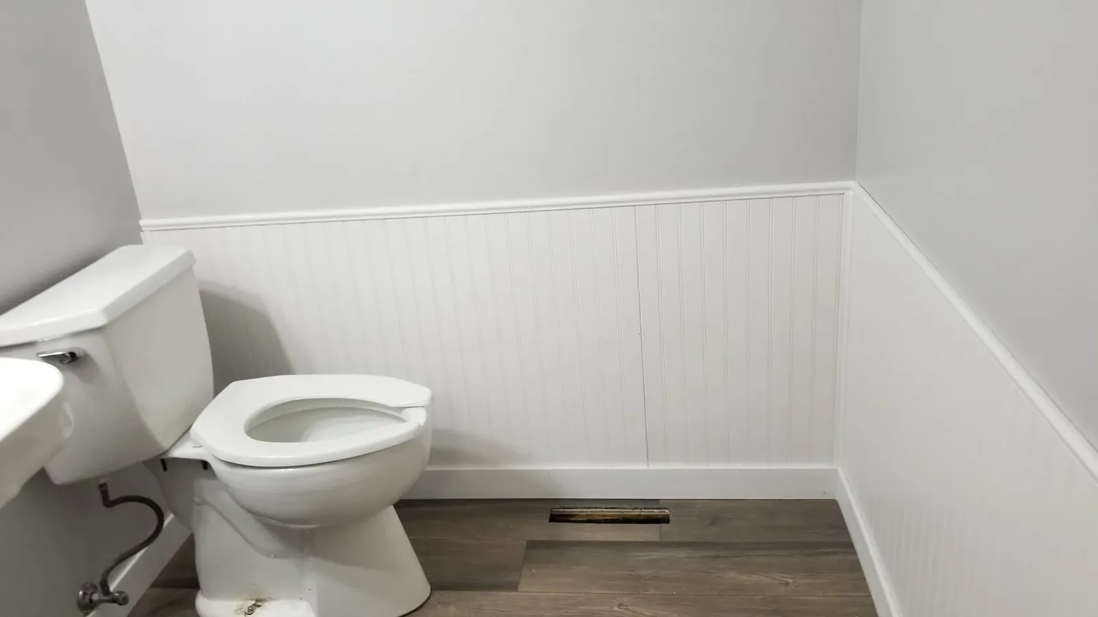 Second finished church powder room with beadboard, new flooring, and fresh paint
